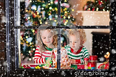 Kids making Christmas ginger bread house Stock Photo