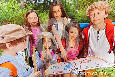 Kids with map on treasure hunt navigation activity Stock Photo