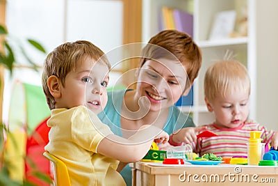 Kids and mother playing colorful clay toy Stock Photo