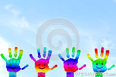 Kids Painted Hand art colorful rainbow hand prints in sky background Stock Photo