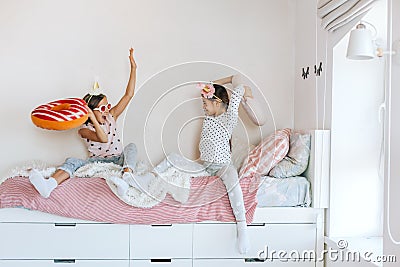 Kids paljamas party in white bedroom interior Stock Photo