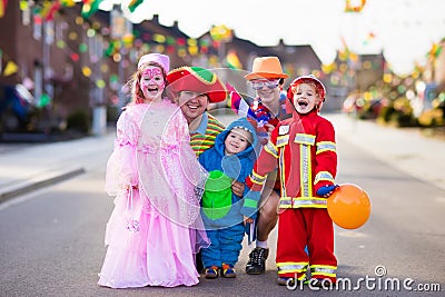 Kids and parents on Halloween trick or treat Stock Photo