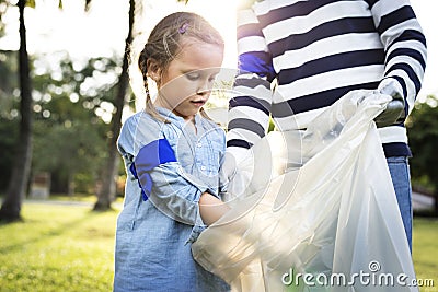 Kids picking up trash in the park Stock Photo