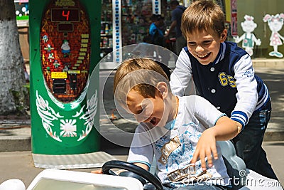 Kids in the play area riding a toy car. Nikolaev, Ukraine Editorial Stock Photo