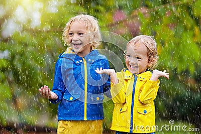 Kids play in autumn rain. Child on rainy day Stock Photo