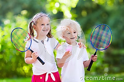 Kids play badminton or tennis in outdoor court Stock Photo