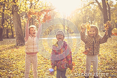 Kids Play with fallen leaves. Stock Photo