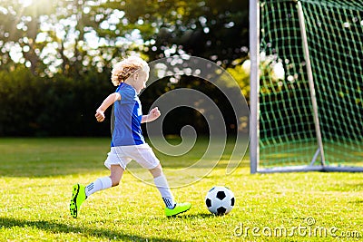 Kids play football. Child at soccer field Stock Photo