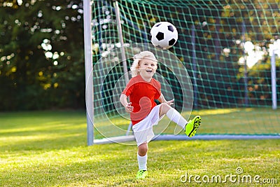 Kids play football. Child at soccer field. Stock Photo