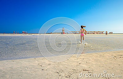Kids play and run on the famous sandy beach of Elafonissi, Crete, Greece. Editorial Stock Photo