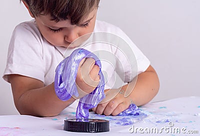 Kids play with slime. Boy stretch handgum or toy slime. Stock Photo