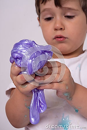 Kids play with slime. Boy stretch handgum or toy slime. Stock Photo