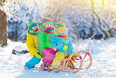 Kids play in snow. Winter sled ride for children Stock Photo