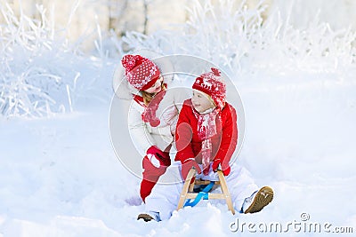 Kids play in snow. Winter sleigh ride for children Stock Photo