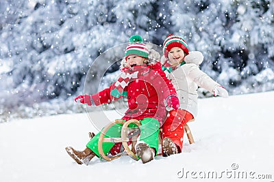 Kids play in snow. Winter sleigh ride for children Stock Photo
