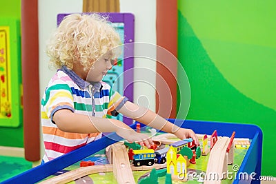Kids play wooden railroad. Child with toy train Stock Photo