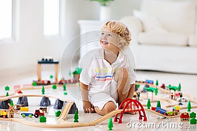Kids play wooden railway. Child with toy train Stock Photo
