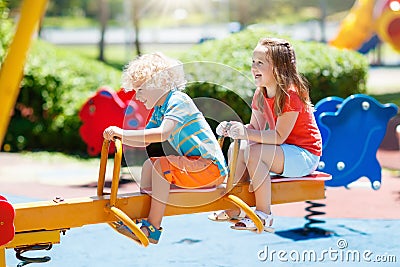 Kids on playground. Children play in summer park. Stock Photo