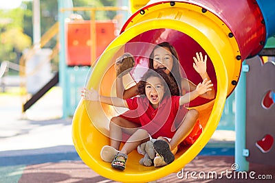 Kids on playground. Children on school yard slide Stock Photo