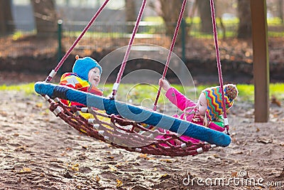 Kids on playground swing Stock Photo