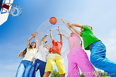 Kids playing basketball with a ball up in sky Stock Photo