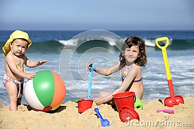 Kids playing with beach toys in the sand Stock Photo