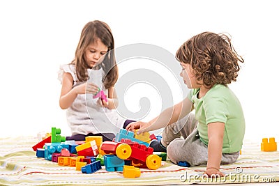 Kids playing with bricks toys Stock Photo