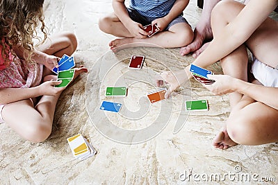 Kids playing cards on the floor Stock Photo