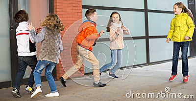 Kids playing catch in yard Stock Photo