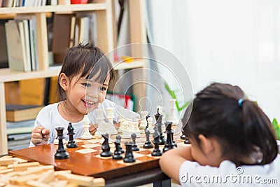 Kids playing chess - one of them just captured a pawn and celebrates Stock Photo