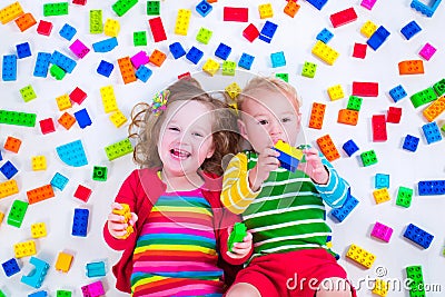 Kids playing with colorful blocks Stock Photo