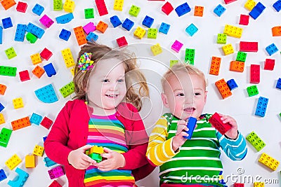 Kids playing with colorful blocks Stock Photo