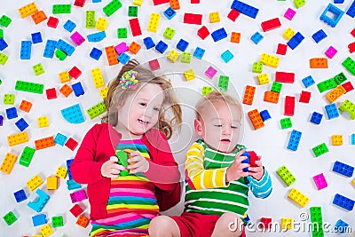 Kids playing with colorful blocks Stock Photo