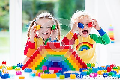 Kids playing with colorful blocks Stock Photo