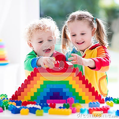 Kids playing with colorful blocks Stock Photo