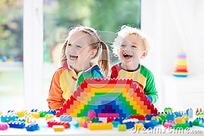 Kids playing with colorful blocks Stock Photo