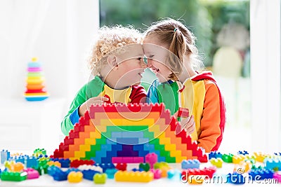 Kids playing with colorful blocks Stock Photo