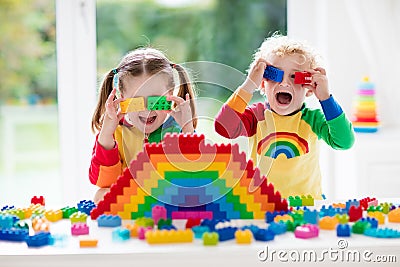 Kids playing with colorful blocks Stock Photo