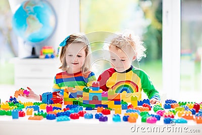 Kids playing with colorful blocks Stock Photo
