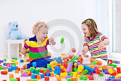 Kids playing with colorful blocks. Stock Photo