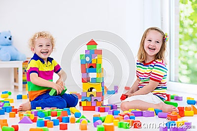 Kids playing with colorful toy blocks Stock Photo