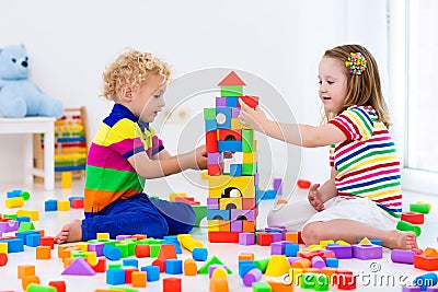 Kids playing with colorful toy blocks Stock Photo