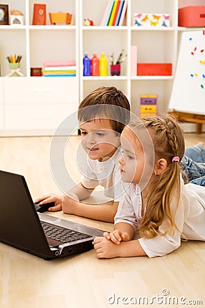Kids playing computer game on laptop Stock Photo