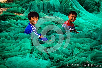 Kids playing in fishing nets Editorial Stock Photo
