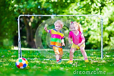 Kids playing football in school yard Stock Photo