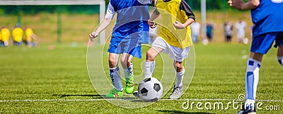 Kids playing football soccer game on sports field. Boys kicking Stock Photo