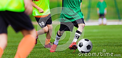 Kids Playing Football Soccer Game on Sports Field. Boys Play Soccer Match Stock Photo