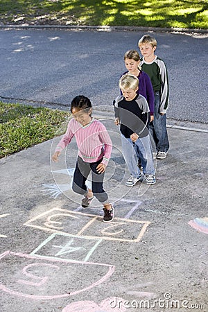 Kids playing hopscotch Stock Photo