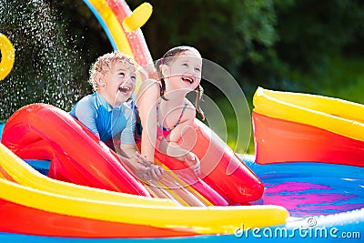 Kids playing in inflatable swimming pool Stock Photo