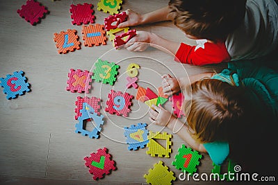 Kids playing with number puzzle, education concept Stock Photo